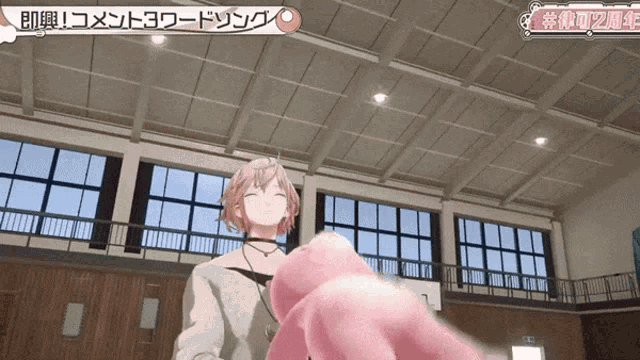 a girl holding a pink teddy bear in a gym with chinese writing