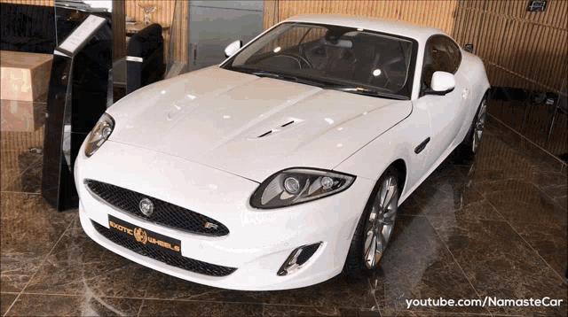 a white jaguar sports car is on display in a youtube video