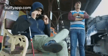 a man is sitting on a bench with his feet up and smoking a cigarette .