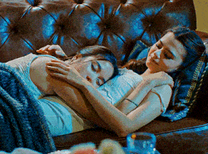 two women hugging each other on a couch