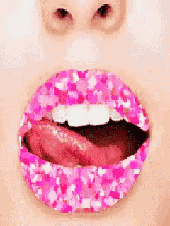 a close up of a woman 's lips with pink glitter .