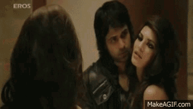 a man and a woman are having sex in a bathroom . the woman is naked and the man is wearing a leather jacket .