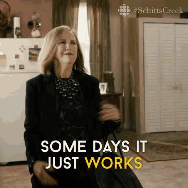 a woman holding a suitcase with the words some days it just works below her