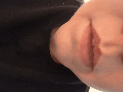 a close up of a person 's face with their mouth open
