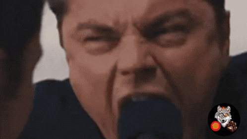 a close up of a man 's face with a wolf sticker in the corner