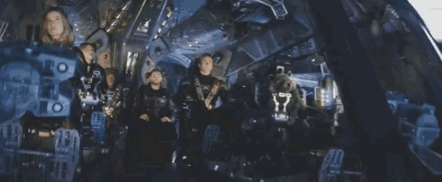 a group of people are sitting in a space ship with a rocket dog in the cockpit