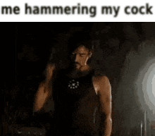 a man in a tank top is hammering his cock .