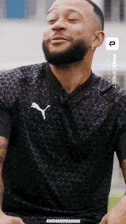 a man with a beard is wearing a black puma jersey