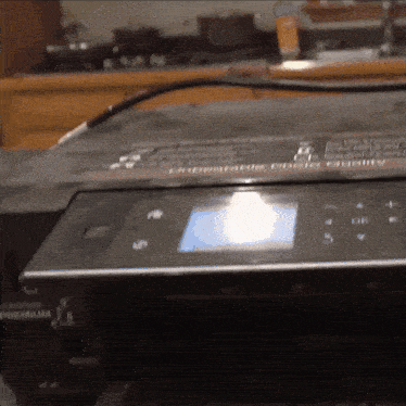 a black toshiba printer is sitting on a counter top