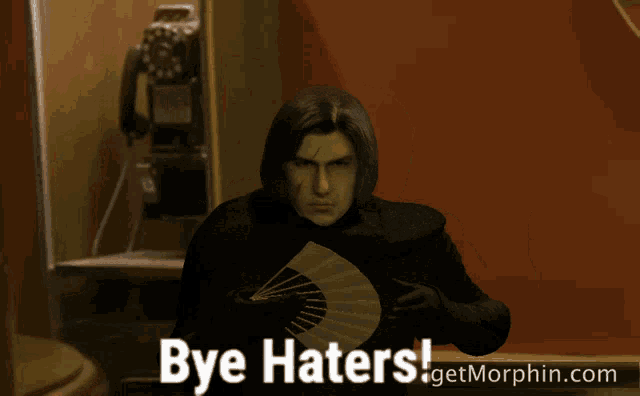 a picture of a man holding a fan with the words bye haters on the bottom