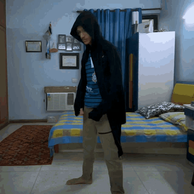 a person wearing a hooded jacket and a shirt that says to