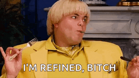 a man in a yellow suit is holding a fork and spoon and says `` i 'm refined , bitch ''