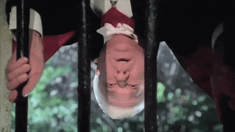 a man in a tuxedo is hanging upside down