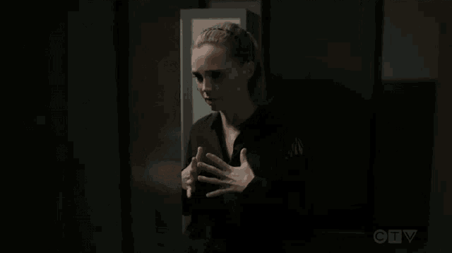 a man and a woman are standing next to lockers in a locker room .