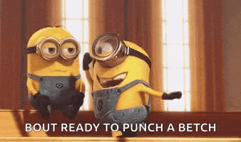 two minions wearing goggles are sitting next to each other on a table .