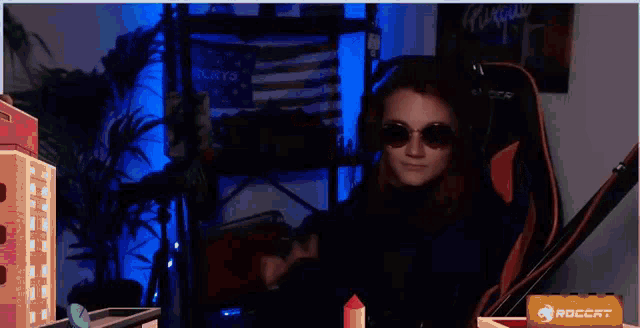 a woman wearing sunglasses and headphones stands in front of a msi sign