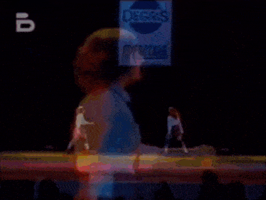 two women with red hair are standing next to each other on a stage .