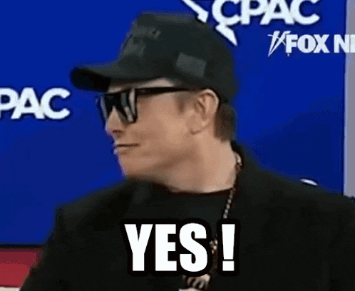 a man wearing sunglasses and a hat is making a yes sign .