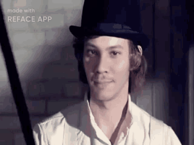 the man is wearing a top hat and a white shirt .