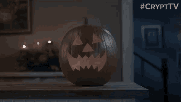 a pumpkin with a face carved into it sits on a table with the hashtag #crypttv