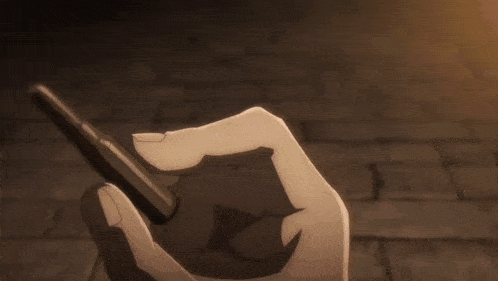 a hand is holding a bullet in a dark room
