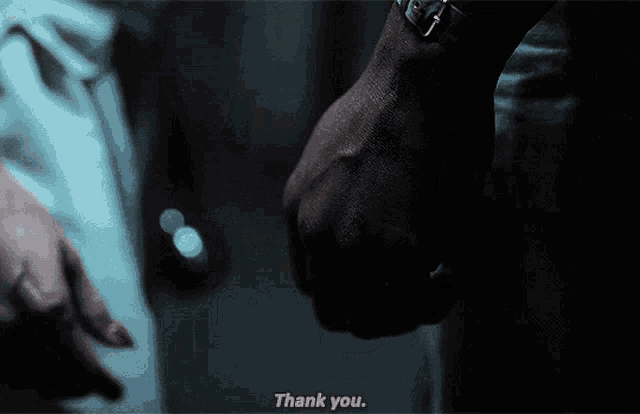 a person holding another person 's hand with the words thank you written on the bottom