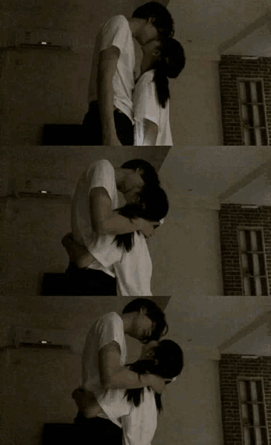 a man and a woman kissing in a dark room