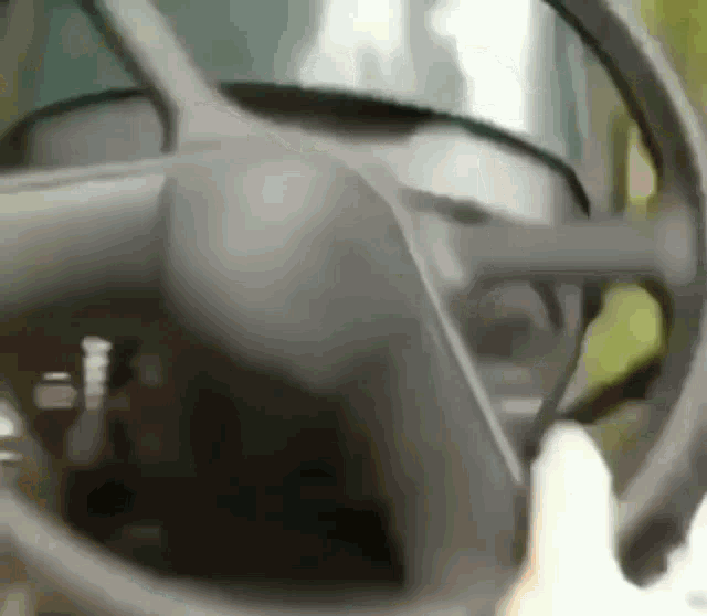 a close up of a car steering wheel and dashboard
