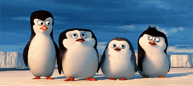 a group of penguins standing next to each other