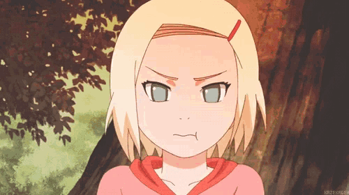 a little girl with blonde hair and blue eyes making a funny face