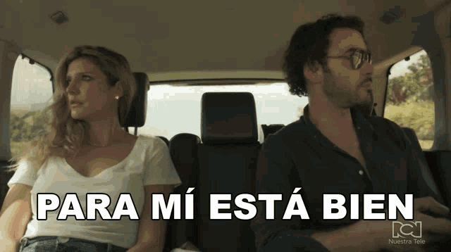 a man and a woman are sitting in a car with para mi esta bien written on the bottom