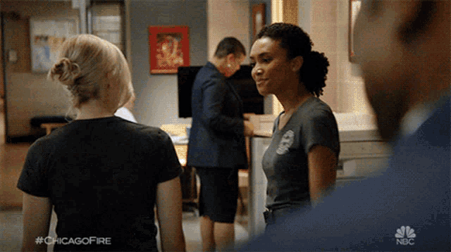 a group of people are standing in a room with the hashtag #chicagofire