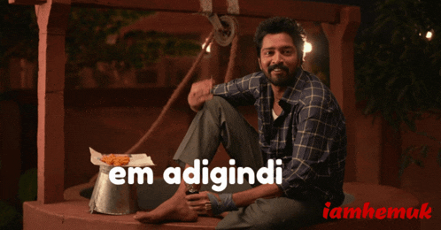 a man is sitting in front of a well with the words em adigini written on the bottom