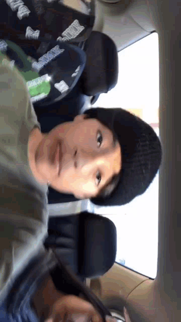 two people in a car one wearing a hat that says smoke