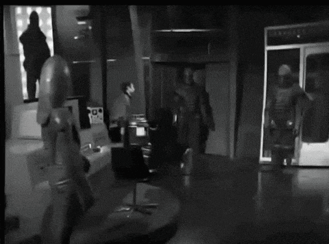 a black and white photo of a room with a sign that says ' eerie ' on it