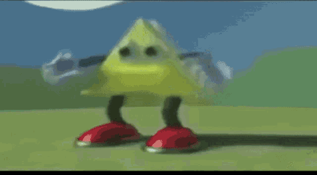 a yellow triangle with red feet and legs is standing on a grassy field .