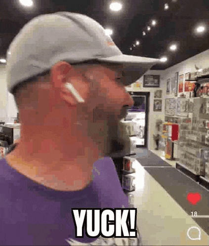 a man wearing a hat and ear buds is standing in a store and says yuck .