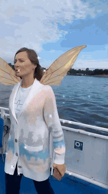 a woman on a boat with fairy wings on her face