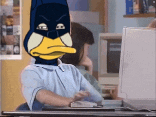 a person with a duck mask on their head is using a computer