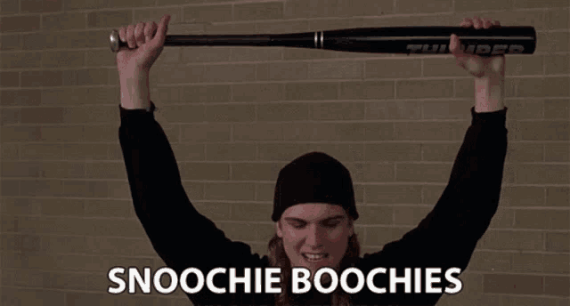 a man is holding a baseball bat over his head with the words snoochie boochies written below him