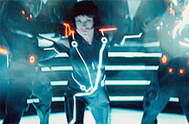 a woman in a futuristic outfit is standing in front of a group of people .