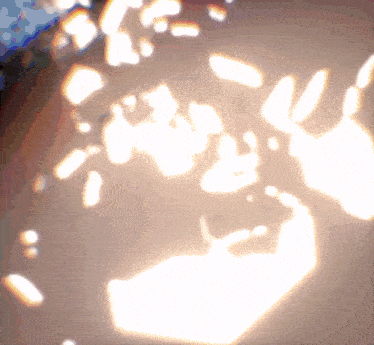 a blurred image of a person 's face with a few spots of light