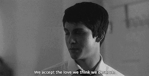 a black and white photo of a woman crying next to a man with the words `` we accept the love we think we deserve '' .