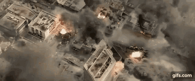 an aerial view of a city with smoke coming out of the buildings .
