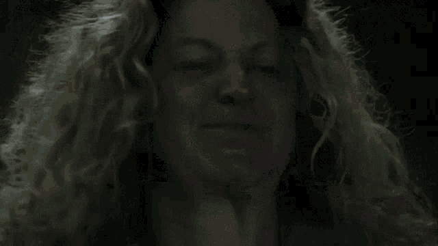a close up of a person 's hair against a black background
