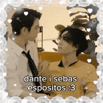 a couple of men are sitting next to each other in a room and kissing .