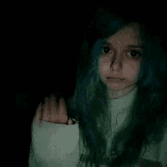 a girl with blue hair and green hair is wearing a sweater