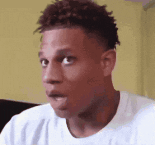 a close up of a man 's face with a surprised look on his face