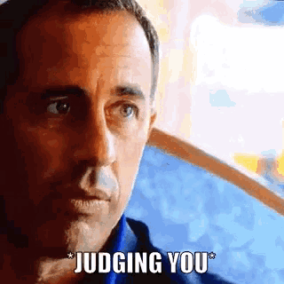 a close up of a man 's face with the caption " judging you "