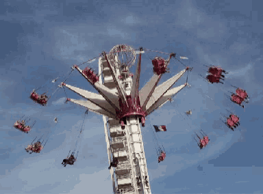 a ferris wheel at an amusement park with a blue sky behind it